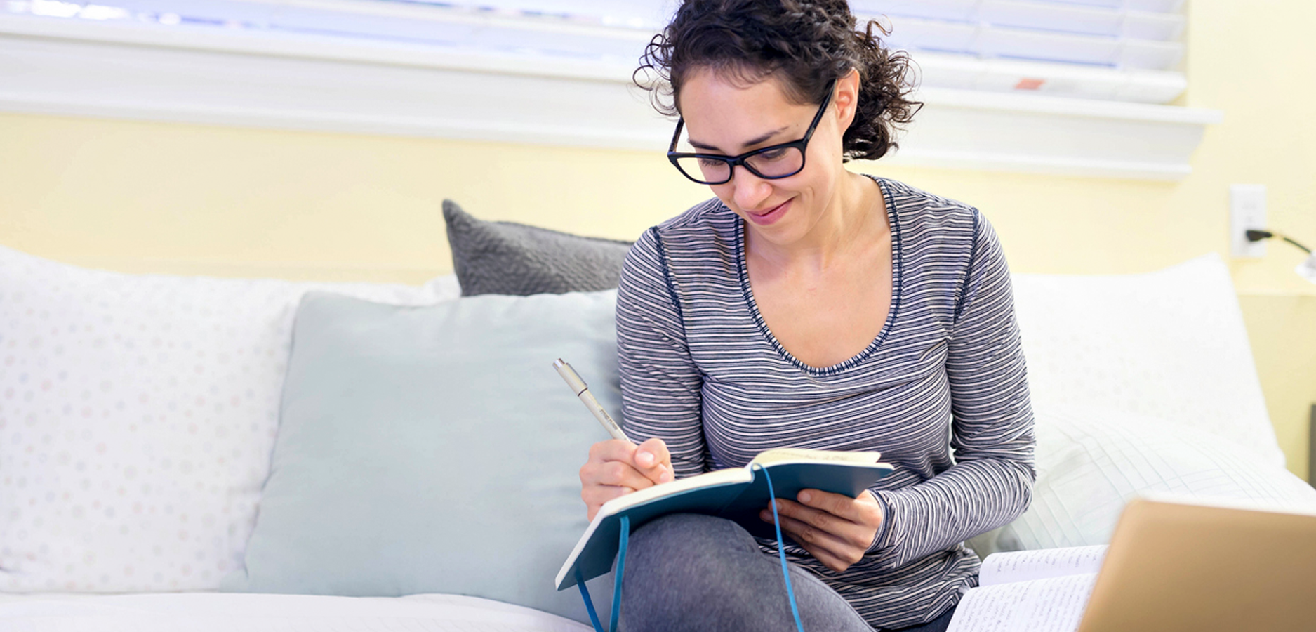 Woman blogging on a couch