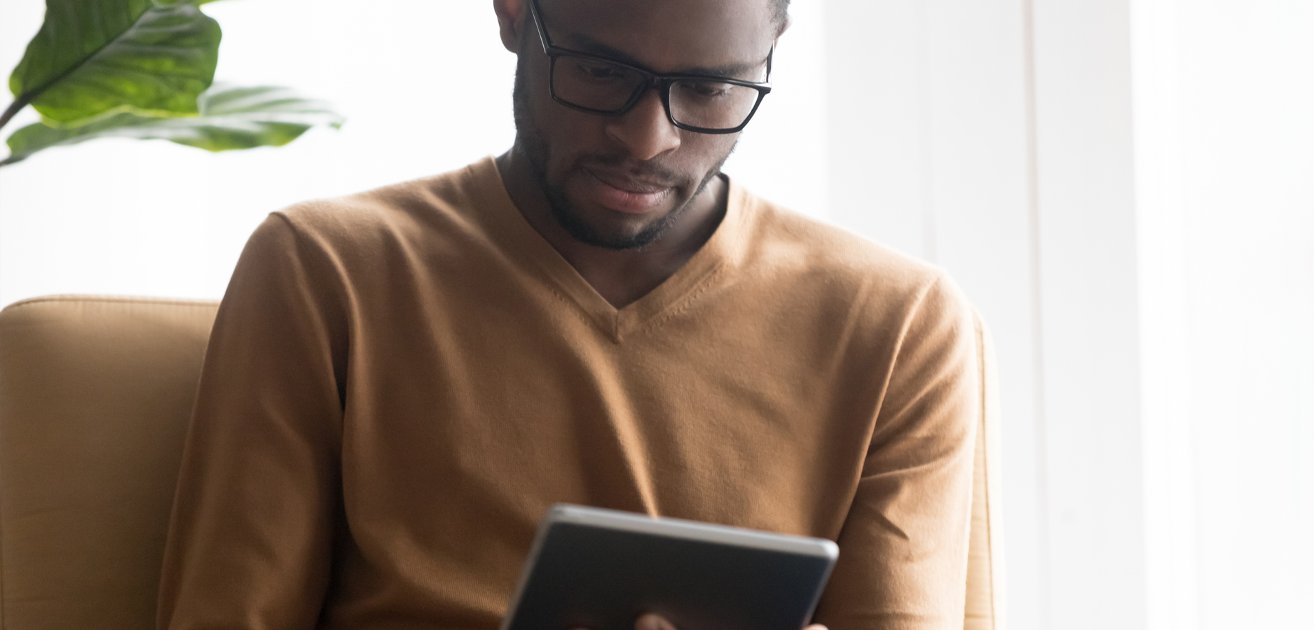 man looking at a tablet for Video counseling banner